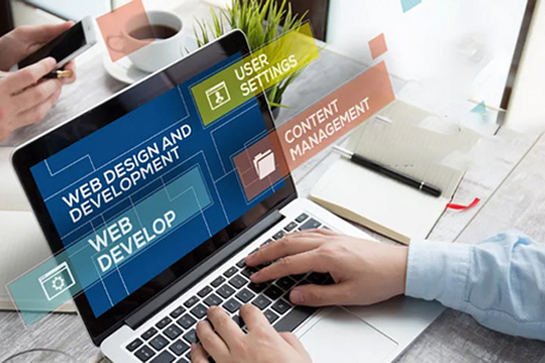 Person typing on laptop displaying web design and development interface with content management labels